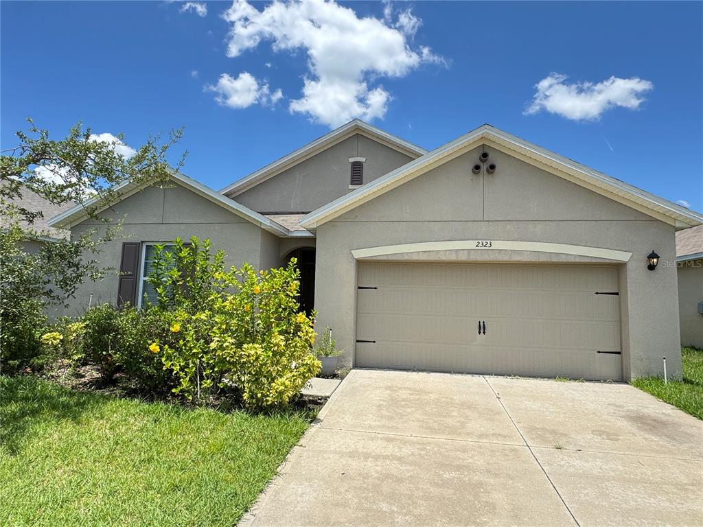 2323 Silverview Drive Lakeland, FL 33811 - Photo 2 of 33 a view of a house with a yard and potted plants