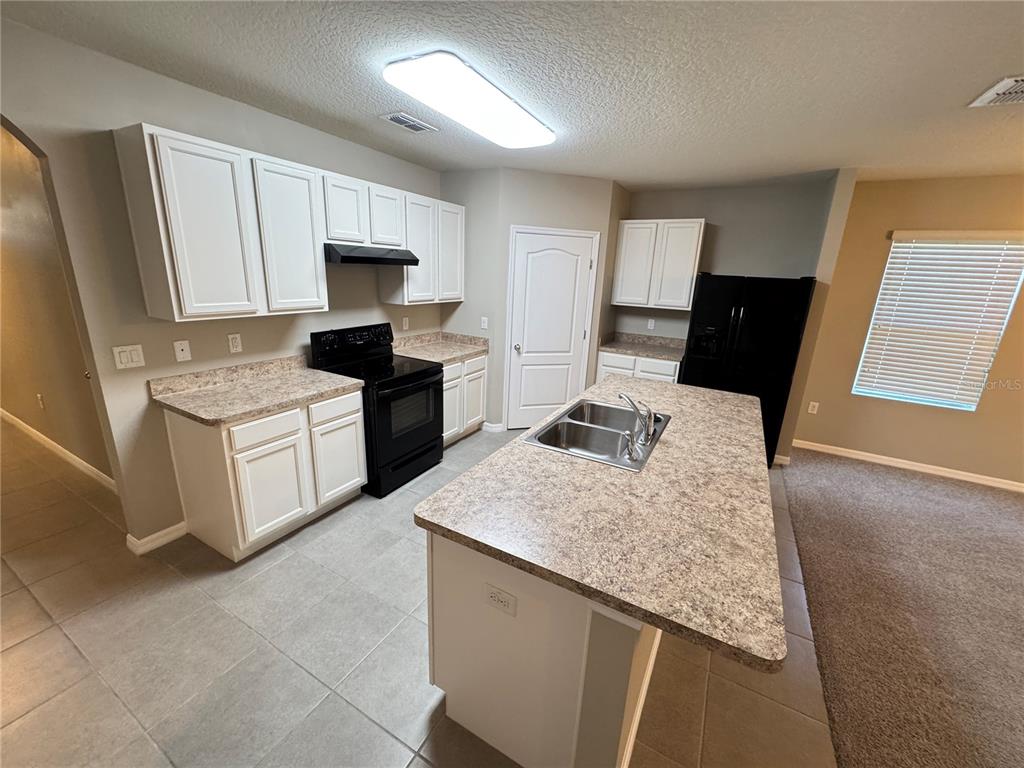 2323 Silverview Drive Lakeland, FL 33811 - Photo 21 of 33 a kitchen with a stove a sink and a refrigerator