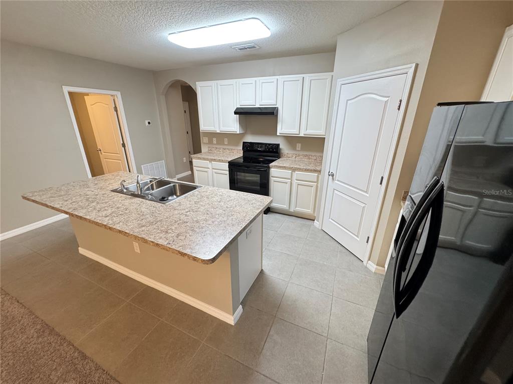2323 Silverview Drive Lakeland, FL 33811 - Photo 22 of 33 a kitchen with a sink stove and refrigerator