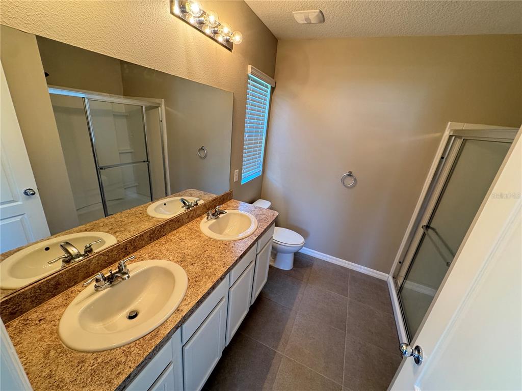 2323 Silverview Drive Lakeland, FL 33811 - Photo 29 of 33 a bathroom with a granite countertop sink and a mirror