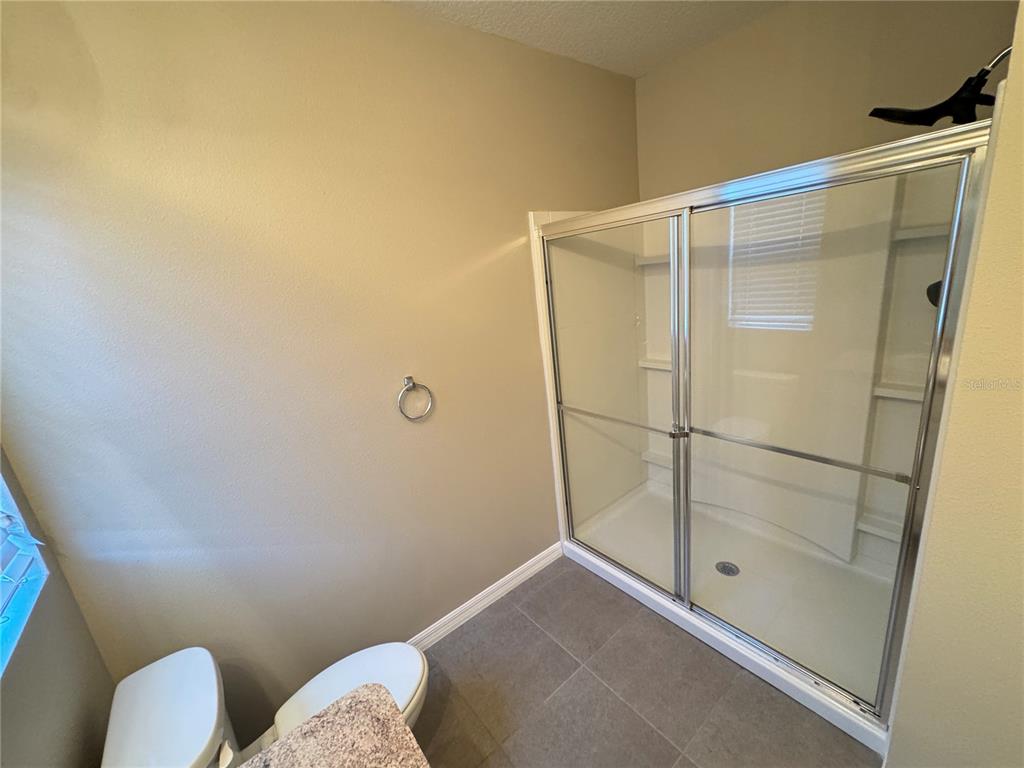 2323 Silverview Drive Lakeland, FL 33811 - Photo 31 of 33 a bathroom with a shower and toilet