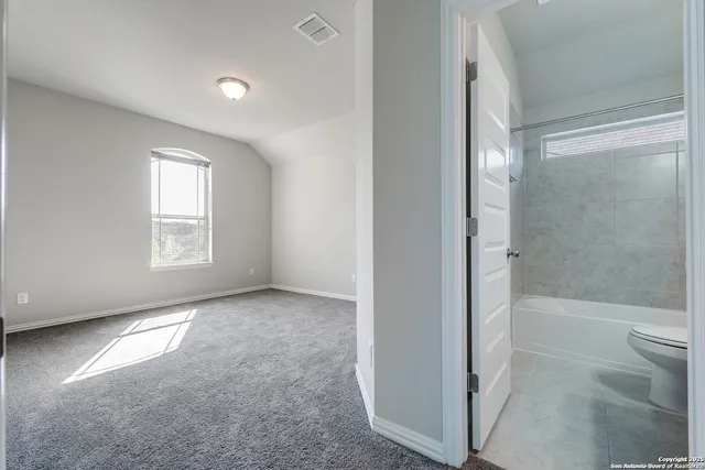 a bathroom with a bathtub and toilet