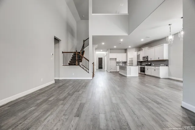 a view of a kitchen and an empty room