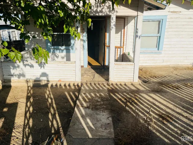 a view of a patio with table and chairs and potted plants