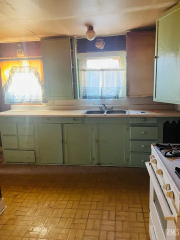 a kitchen with a sink and a stove top oven