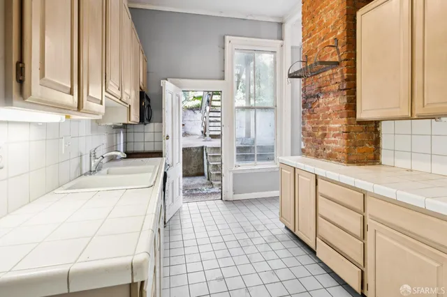 a view of a kitchen with wooden floor and refrigerator