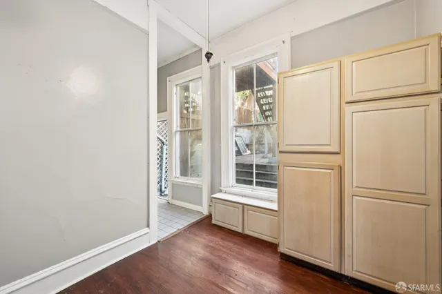 wooden floor in an empty room with a window