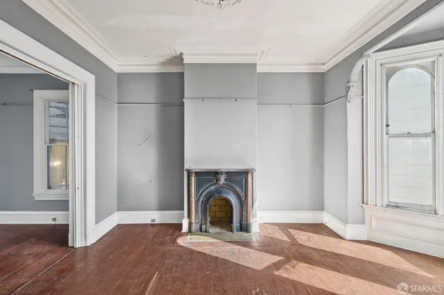 a view of a livingroom with a fireplace wooden floor and carpet