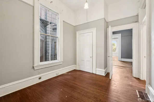 a view of a livingroom with a fireplace wooden floor and window