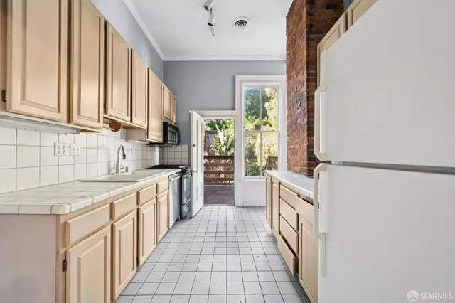 a backyard of a house with barbeque oven and table