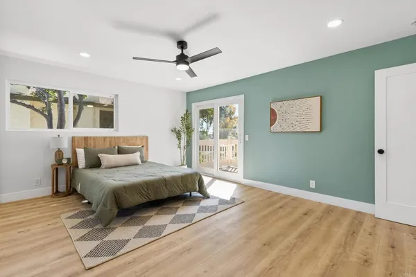 a spacious bedroom with a bed and a chandelier