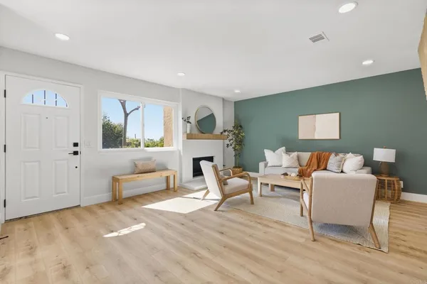 a living room with furniture and a wooden floor