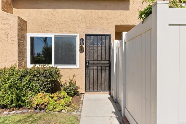 a view of a house with a flower garden