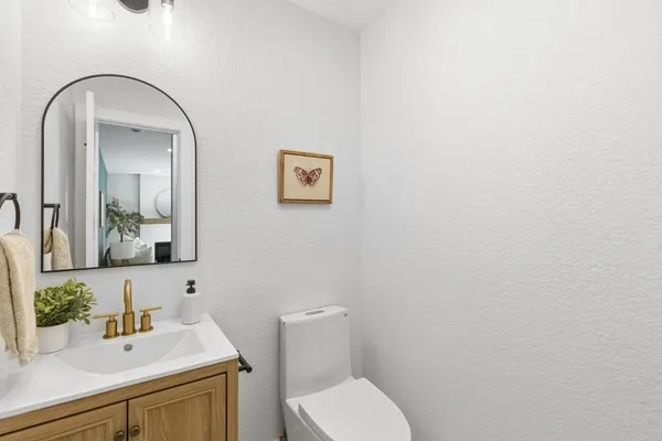 a bathroom with a toilet sink and mirror
