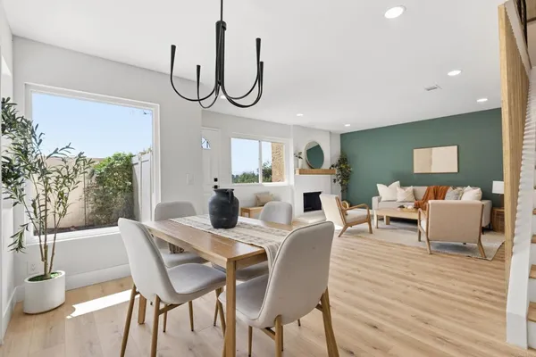 a view of a dining room with furniture window and wooden floor