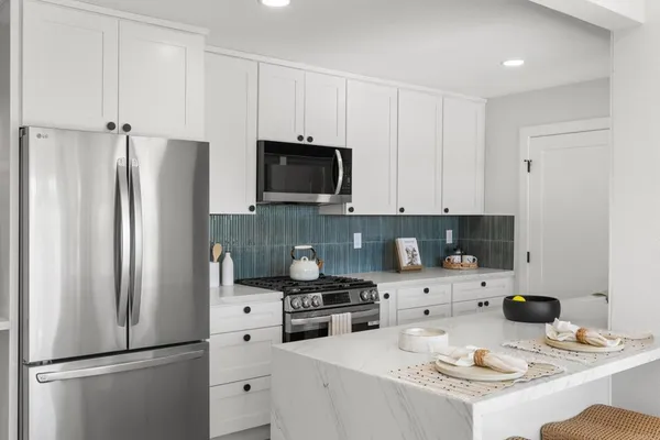 a kitchen with stainless steel appliances a refrigerator stove and sink