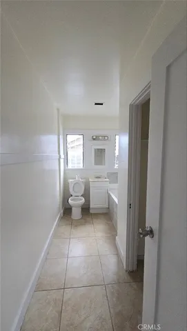 a bathroom with a sink a bathtub and a mirror