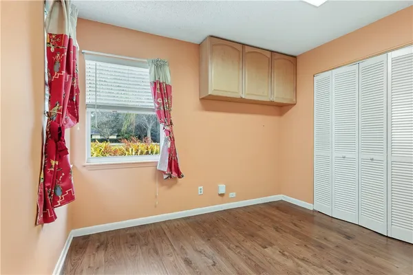 a view of a room with wooden floor and windows