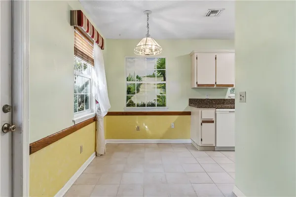 a view of a kitchen cabinets and a window