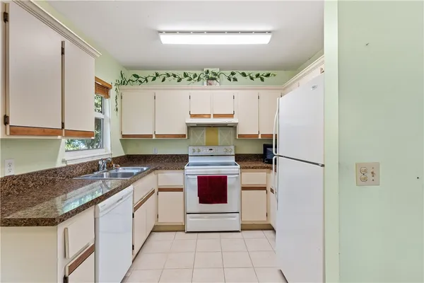 a kitchen with stainless steel appliances granite countertop a sink and a stove