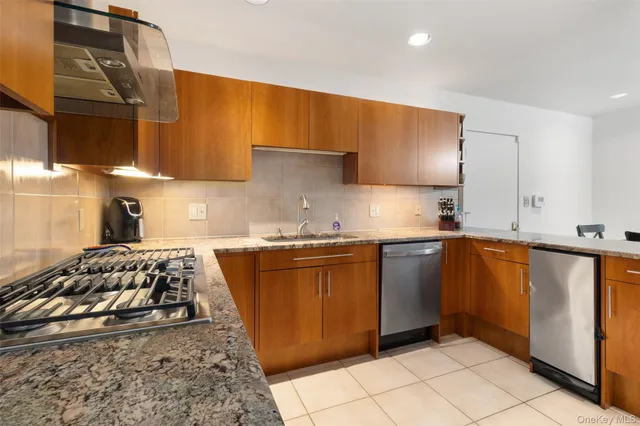 a kitchen with stainless steel appliances a stove a sink and a microwave