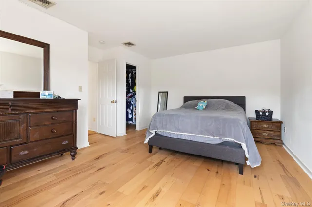 a bathroom with a granite countertop sink a toilet a mirror and shower curtain