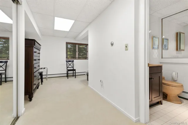 a bedroom with a bed tv and a window