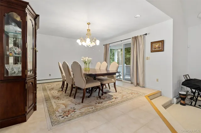 a view of a dining room with furniture and chandelier