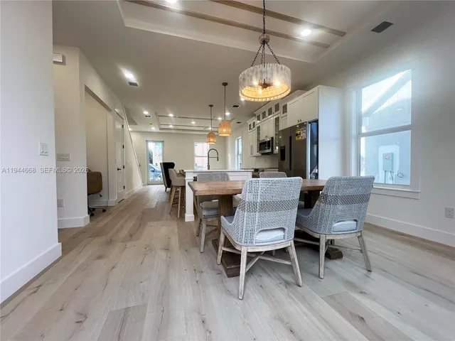a view of a dining room with furniture wooden floor and chandelier