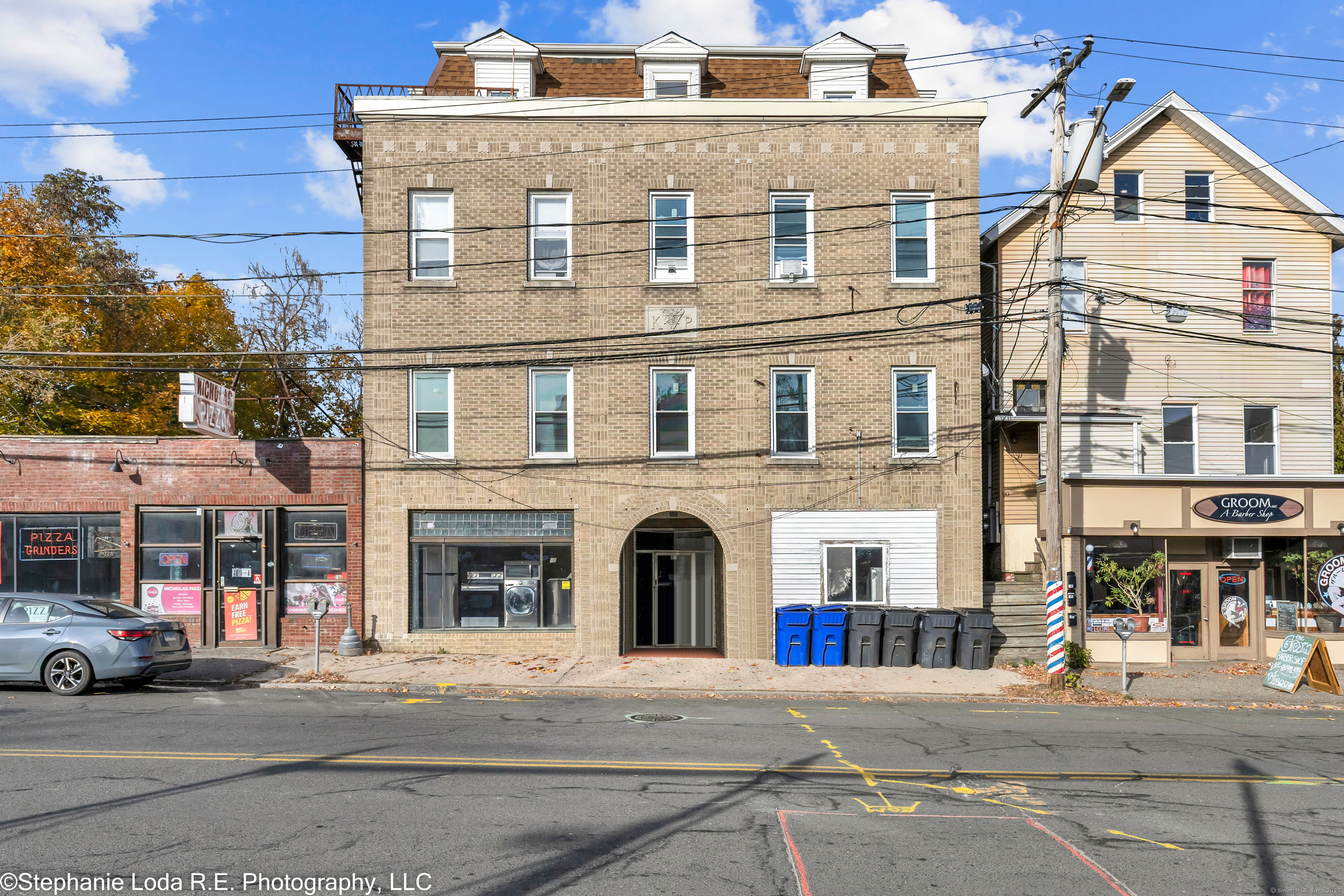 82 Water Street, Unit 6 Torrington, CT 06790 - Photo 1 of 14 a front view of a building with many windows