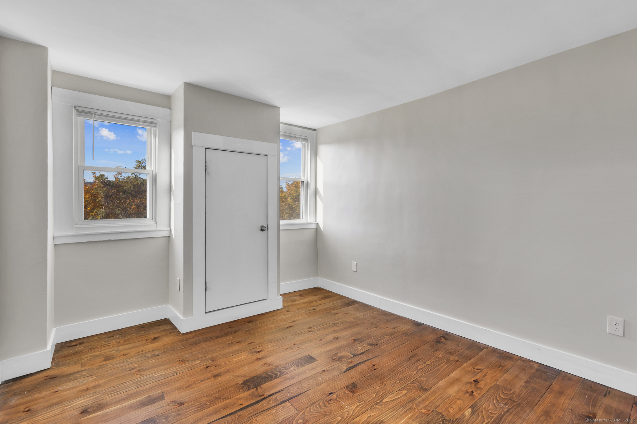 82 Water Street, Unit 6 Torrington, CT 06790 - Photo 10 of 14 a view of an empty room with wooden floor and a window