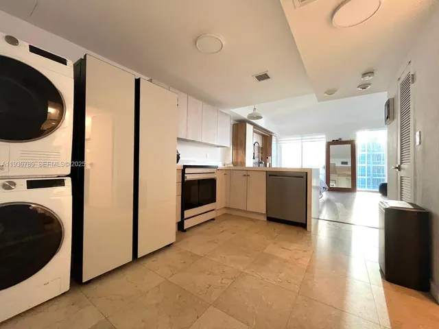 a view of a kitchen with a stove fridge and wooden floor