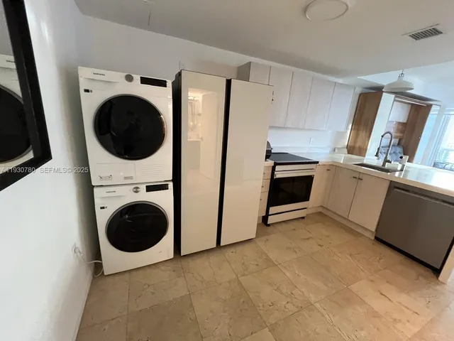a view of a kitchen with washer and dryer