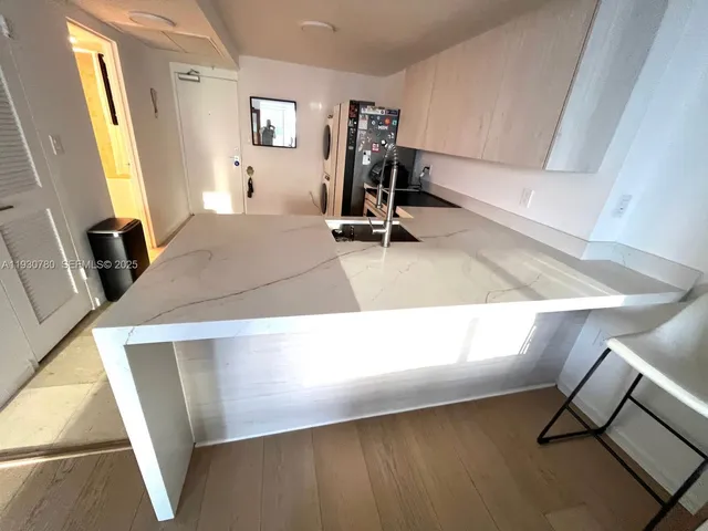 a view of a living room with furniture and a window