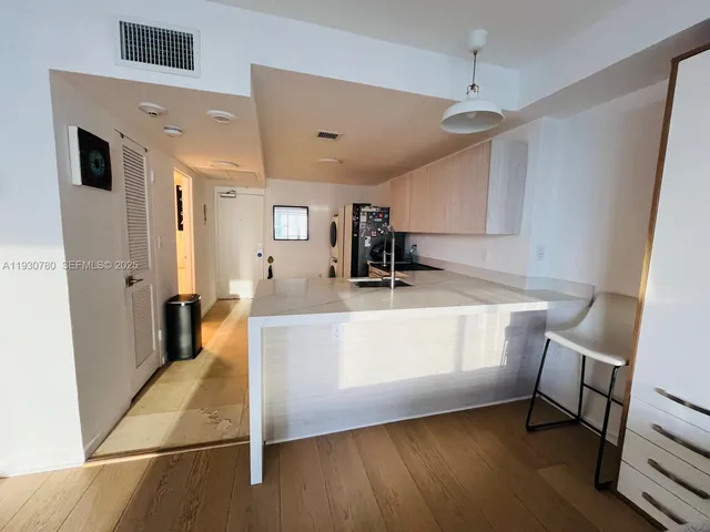 a view of living room with furniture and wooden floor