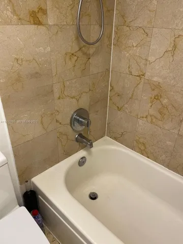 a bathroom with a sink a toilet and a shower