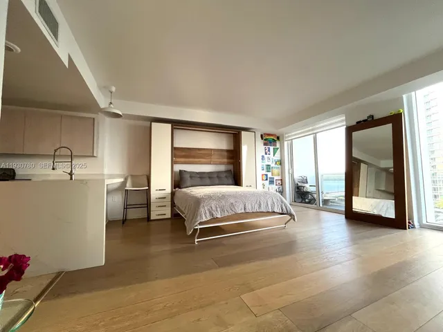 a spacious bedroom with a large bed and a large window