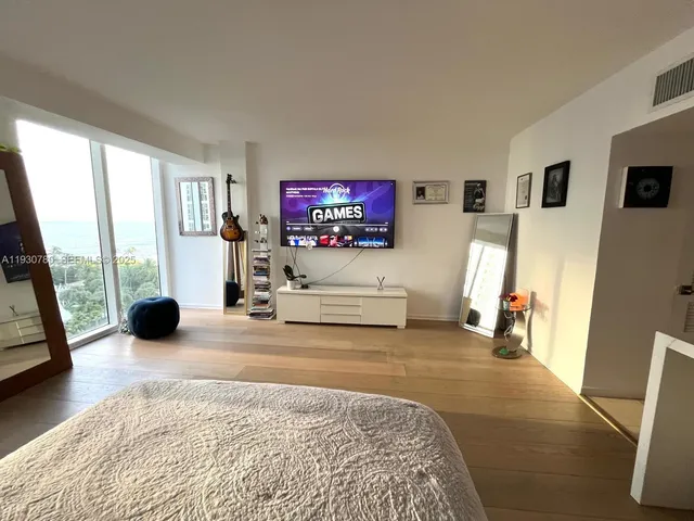 a view of a livingroom with furniture and a flat screen tv