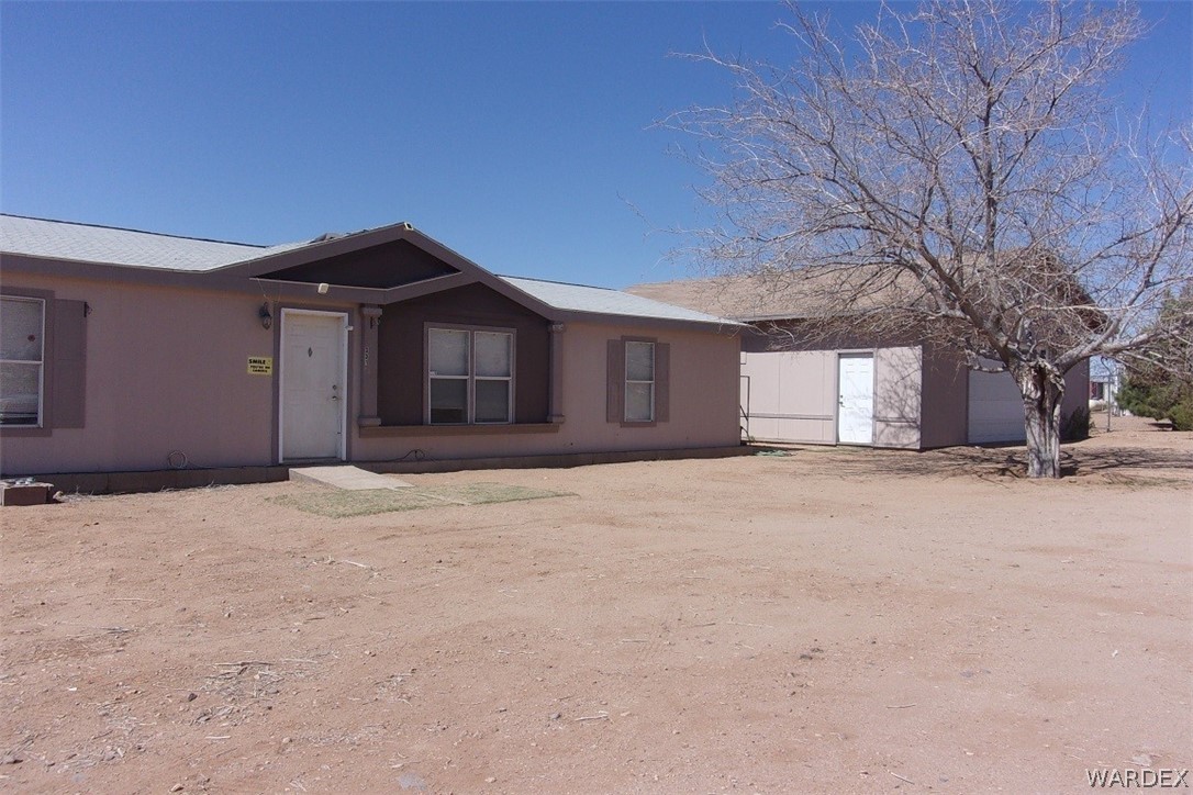 3313 Houck Road Golden Valley, AZ 86413 - Photo 2 of 33 a house with trees in front of it