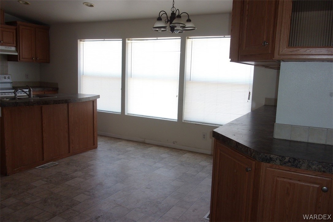 3313 Houck Road Golden Valley, AZ 86413 - Photo 8 of 33 a kitchen with windows and refrigerator