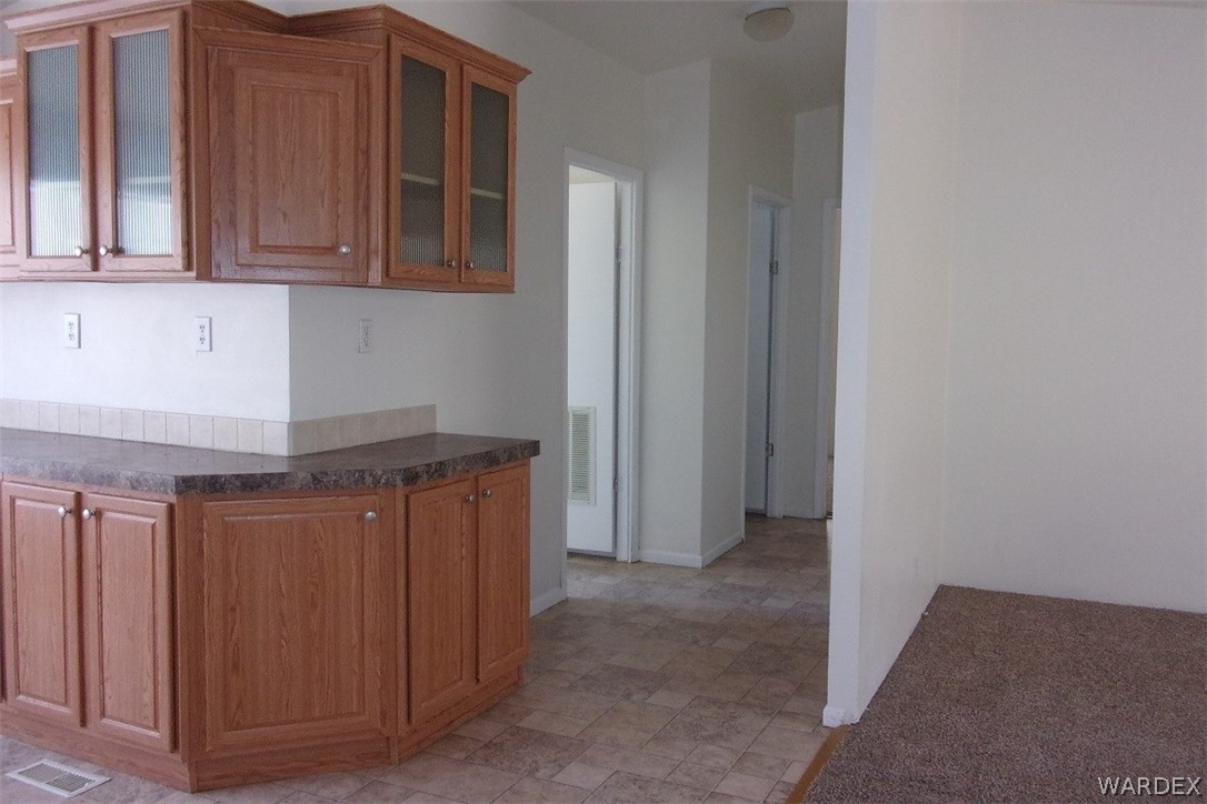 3313 Houck Road Golden Valley, AZ 86413 - Photo 10 of 33 a kitchen with stainless steel appliances granite countertop white cabinets and refrigerator