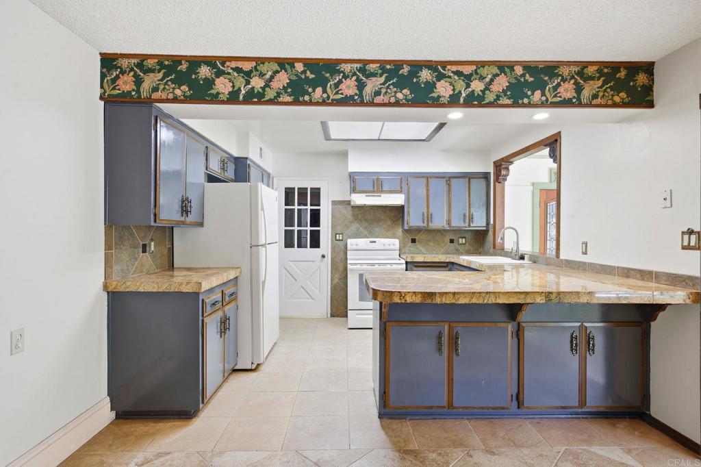 2807 South Grade Road Alpine, CA 91901 - Photo 13 of 42 a kitchen with kitchen island a sink counter top space and appliances