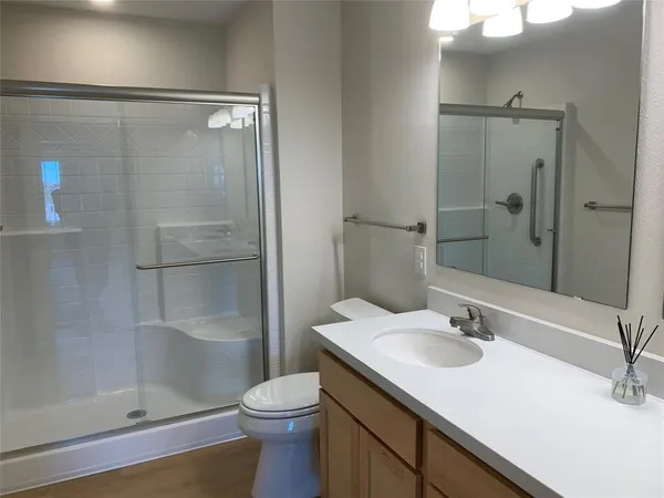 a bathroom with a sink a light fixture and a mirror