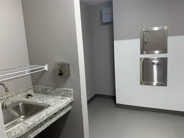 a kitchen with a sink and refrigerator