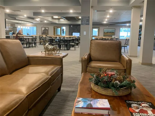 a living room with furniture and a dining table