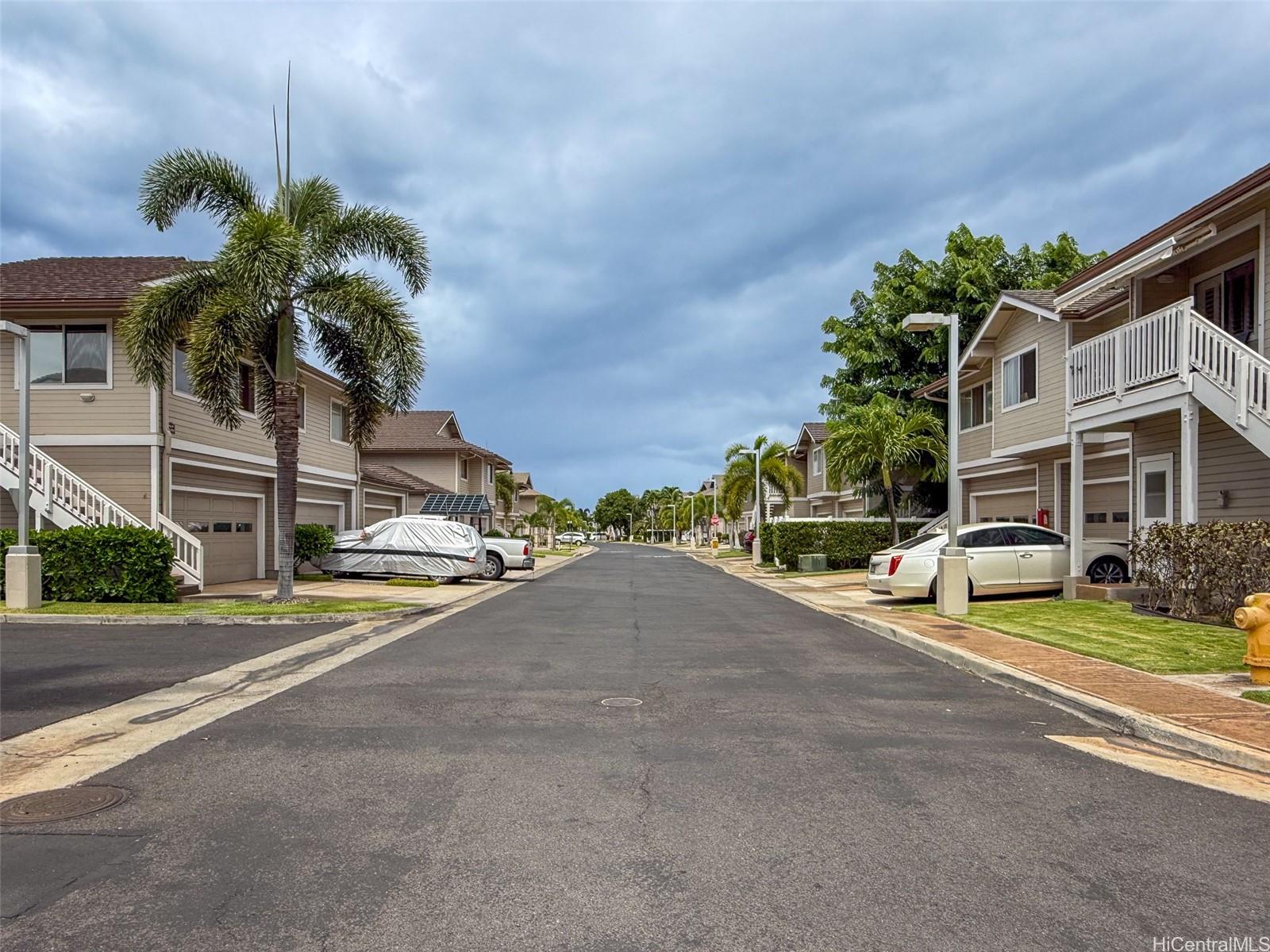92-1519 Ali'inui Drive, Unit 12A Kapolei, HI 96707 - Photo 15 of 25 a view of a street with houses on both side