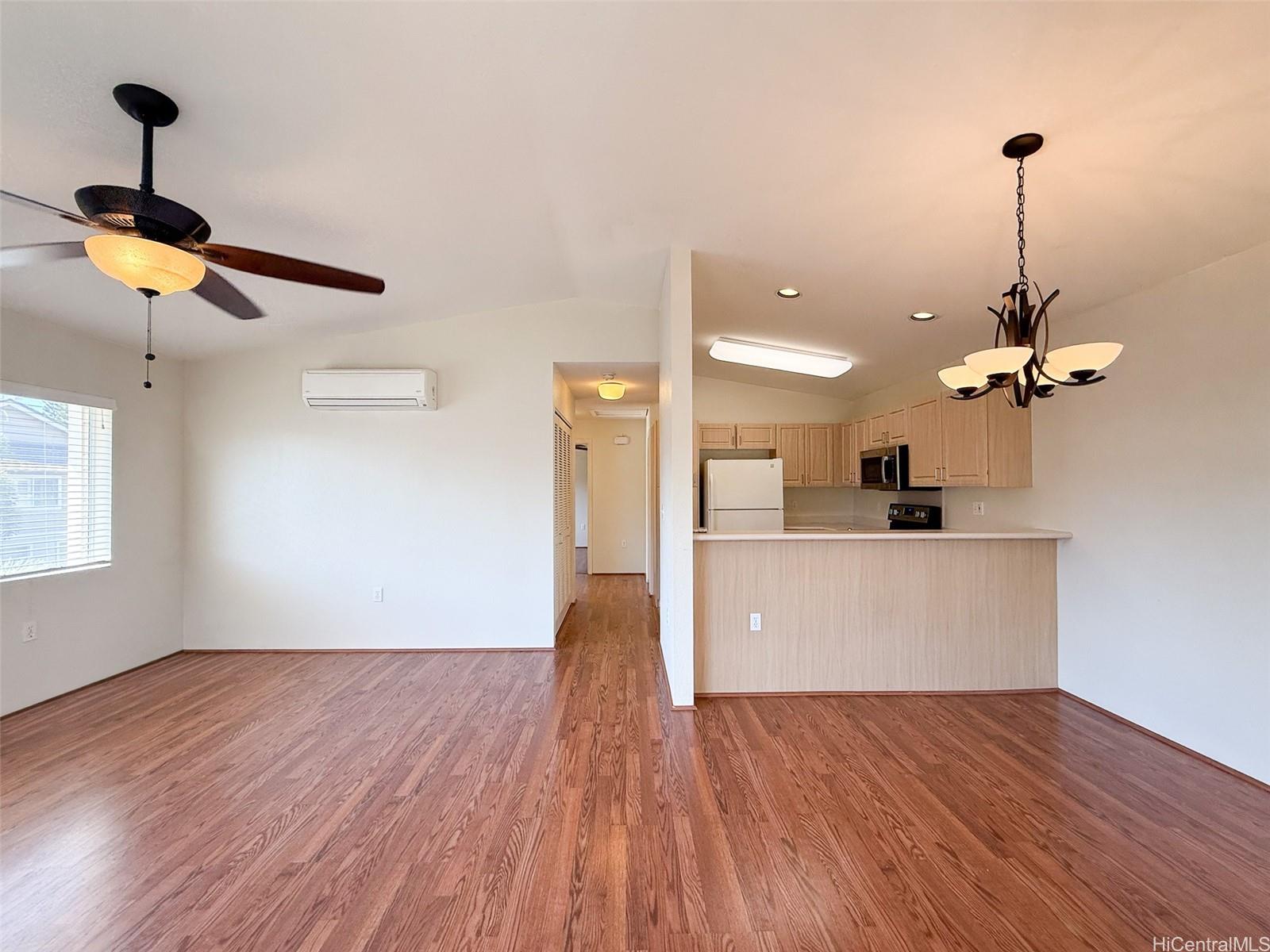 92-1519 Ali'inui Drive, Unit 12A Kapolei, HI 96707 - Photo 21 of 25 a view of a kitchen with wooden floor and a ceiling fan