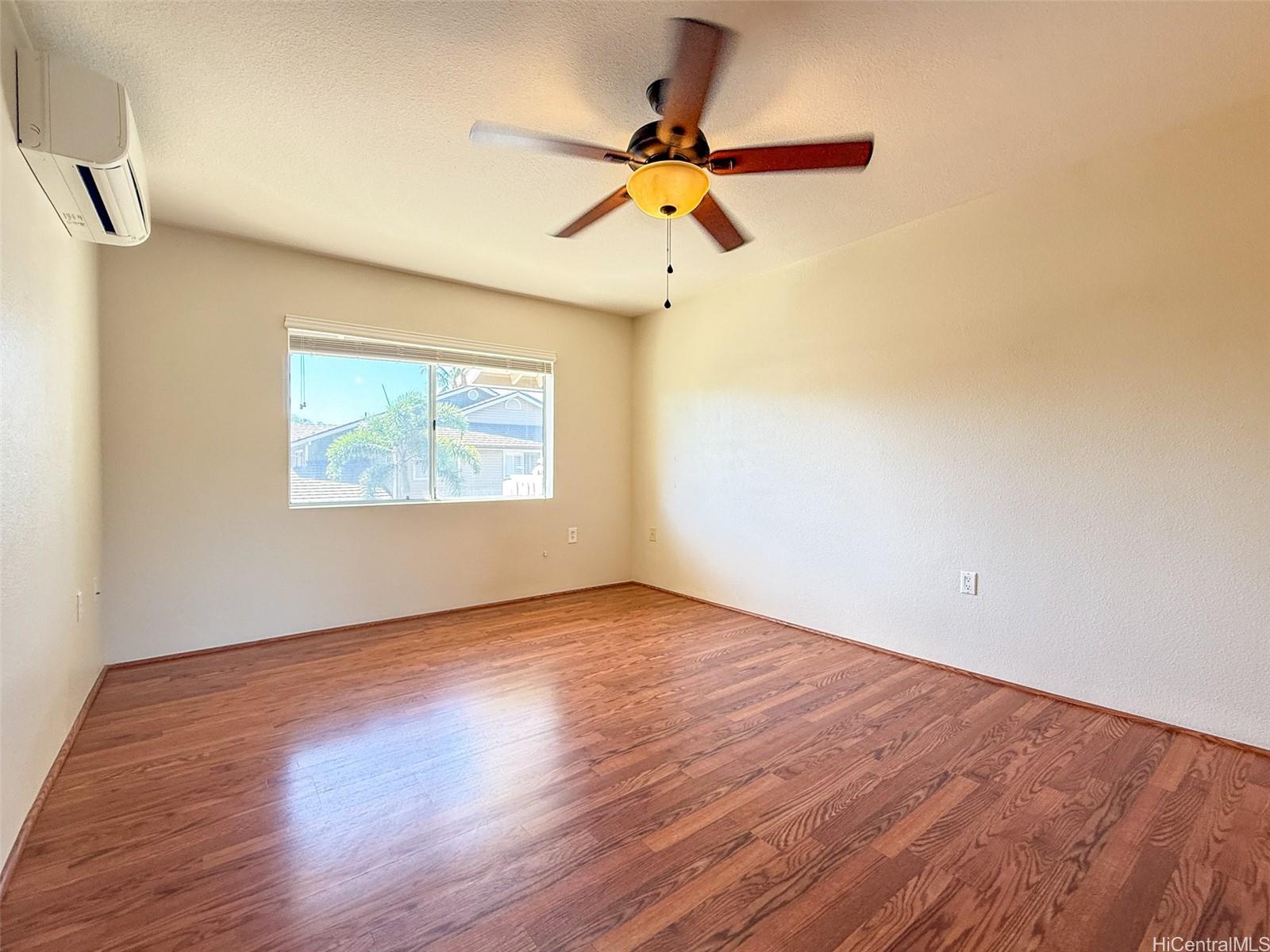 92-1519 Ali'inui Drive, Unit 12A Kapolei, HI 96707 - Photo 24 of 25 a view of an empty room with wooden floor and a window