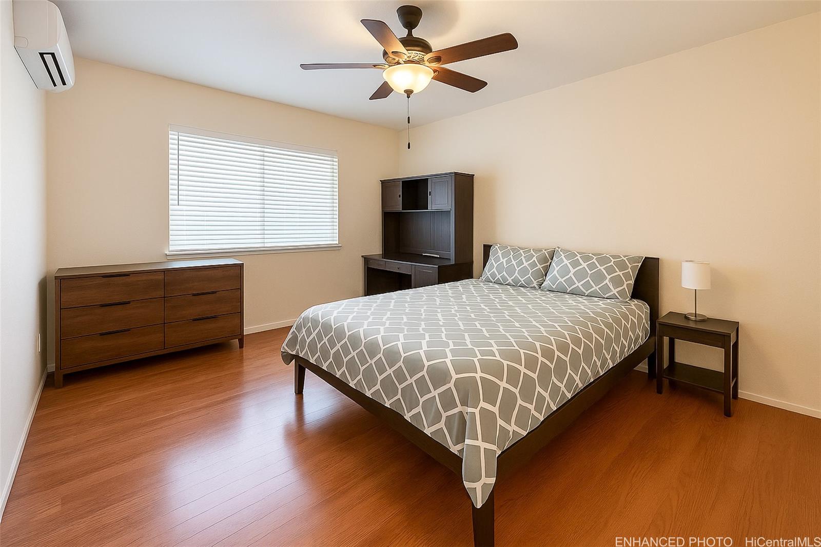 92-1519 Ali'inui Drive, Unit 12A Kapolei, HI 96707 - Photo 5 of 25 a bedroom with a bed ceiling fan and a window