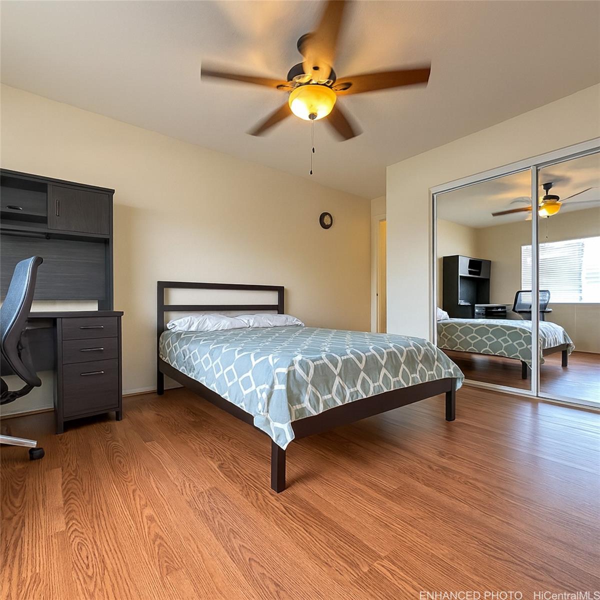 92-1519 Ali'inui Drive, Unit 12A Kapolei, HI 96707 - Photo 7 of 25 a bedroom with a bed and wooden floor